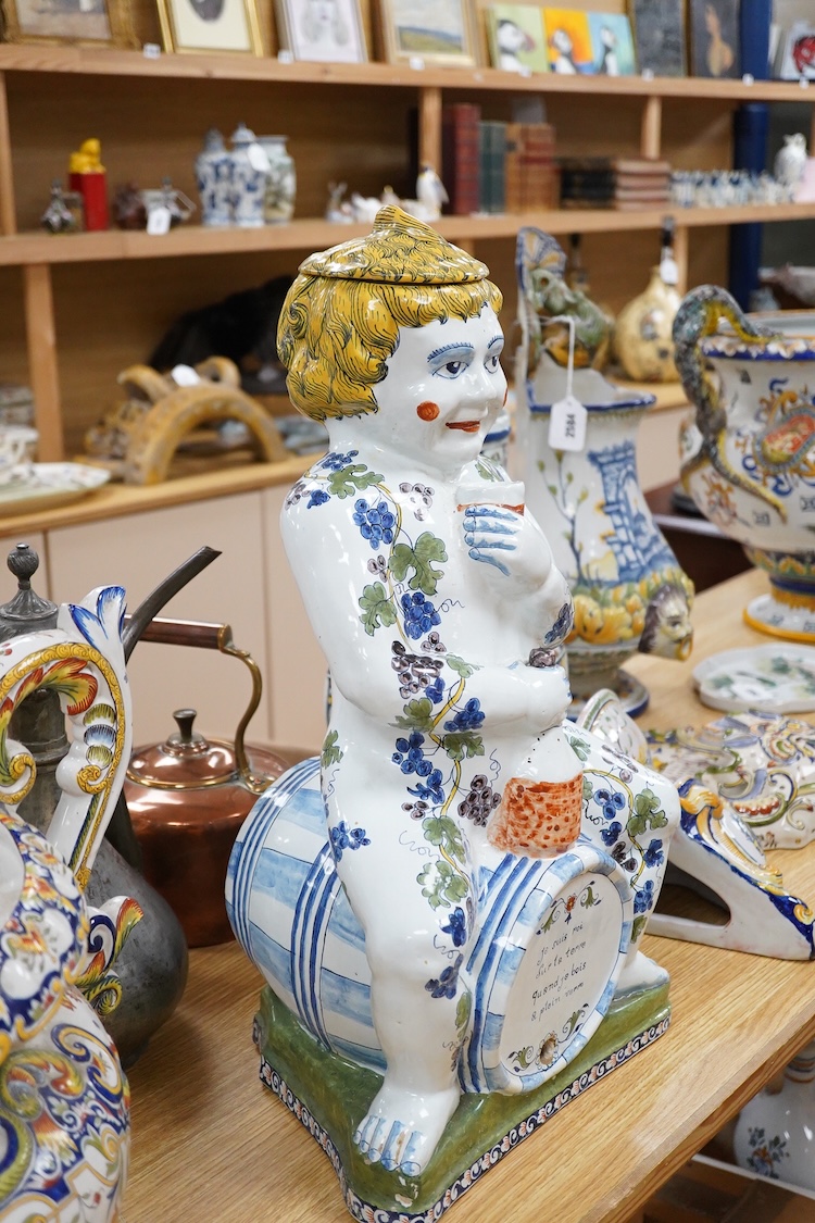 A large Brussels style faience Bacchus figural wine cistern, 62cm high